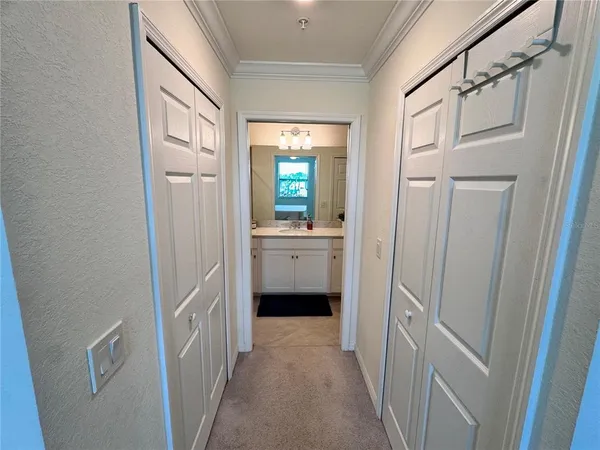 a view of a hallway with a cabinet and a mirror