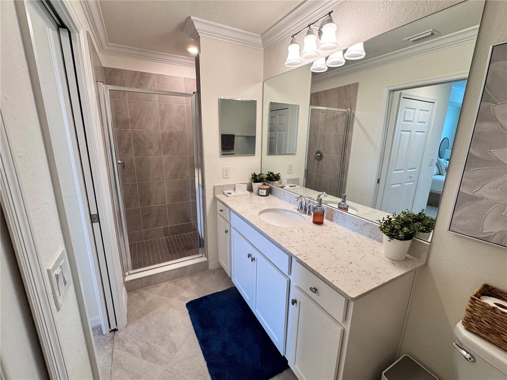 17724 Gawthrop Drive, Unit 304 Bradenton, FL 34211 - Photo 38 of 38 a bathroom with a sink a mirror a vanity and a shower