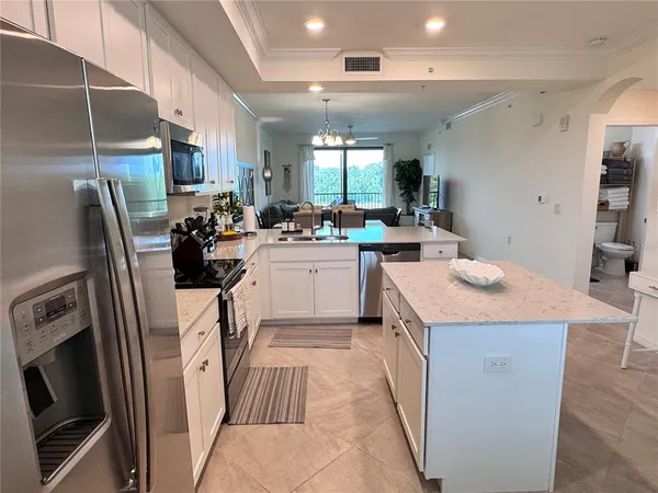 a kitchen with sink a refrigerator and cabinets