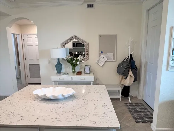 a living room with table and chairs