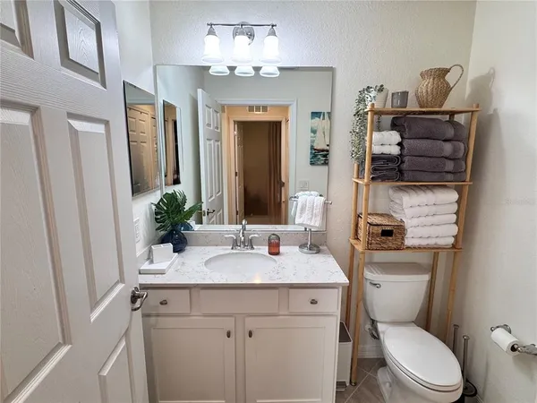 a bathroom with a toilet a sink and a mirror