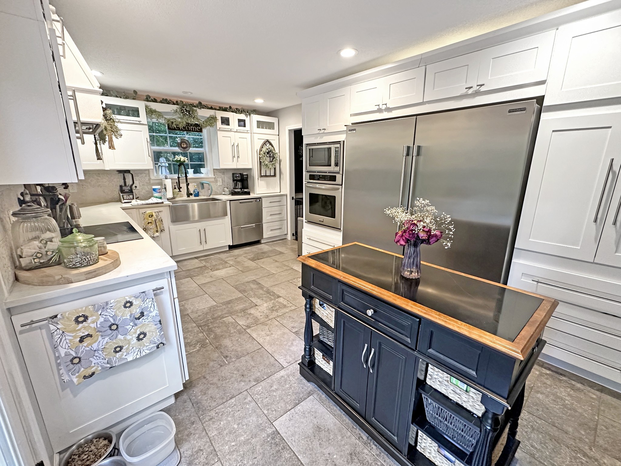 1016 Keyway Drive Pleasant View, TN 37146 - Photo 13 of 30 a kitchen with stainless steel appliances kitchen island granite countertop a refrigerator and cabinets