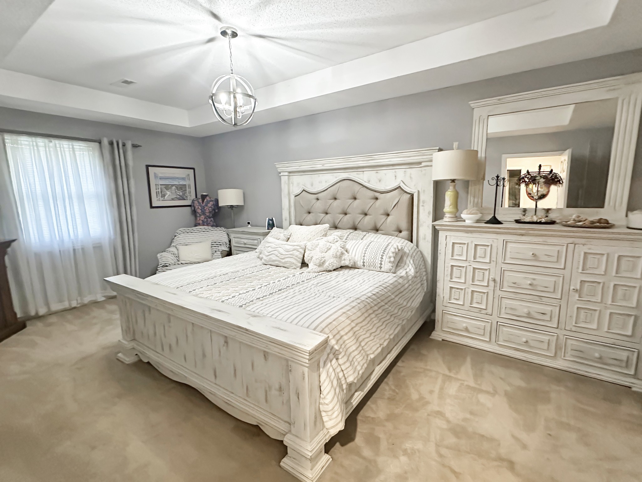 1016 Keyway Drive Pleasant View, TN 37146 - Photo 20 of 30 a bedroom with a large bed and a chandelier