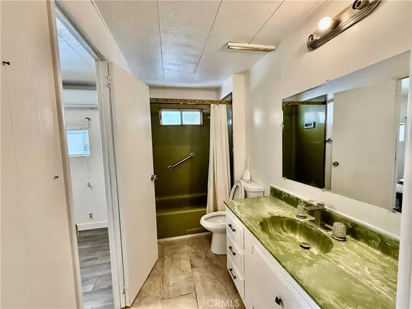 a bathroom with a double vanity sink and a mirror