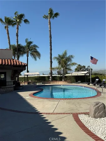 a view of a house with a swimming pool and a yard