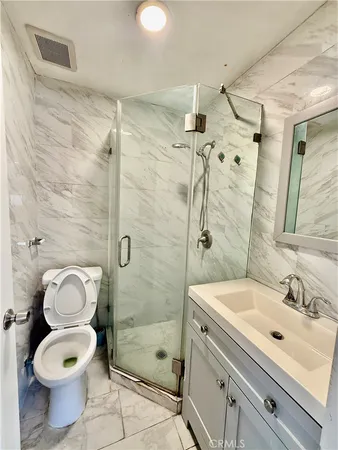 a bathroom with a sink toilet and shower