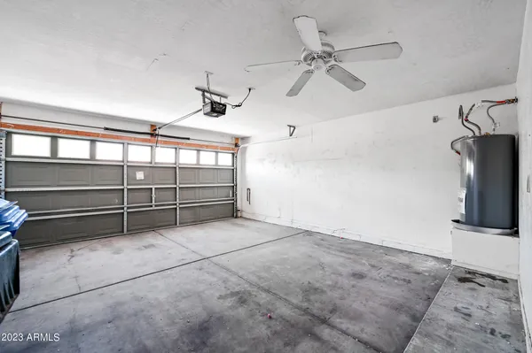 a view of a garage with furniture and a ceiling fan