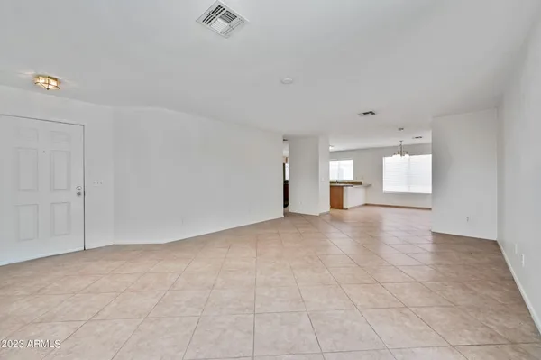 a view of empty room with wooden floor and cabinet