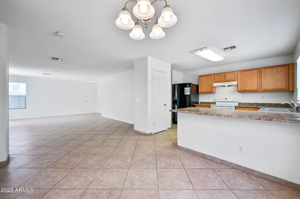 a view of kitchen with sink and refrigerator