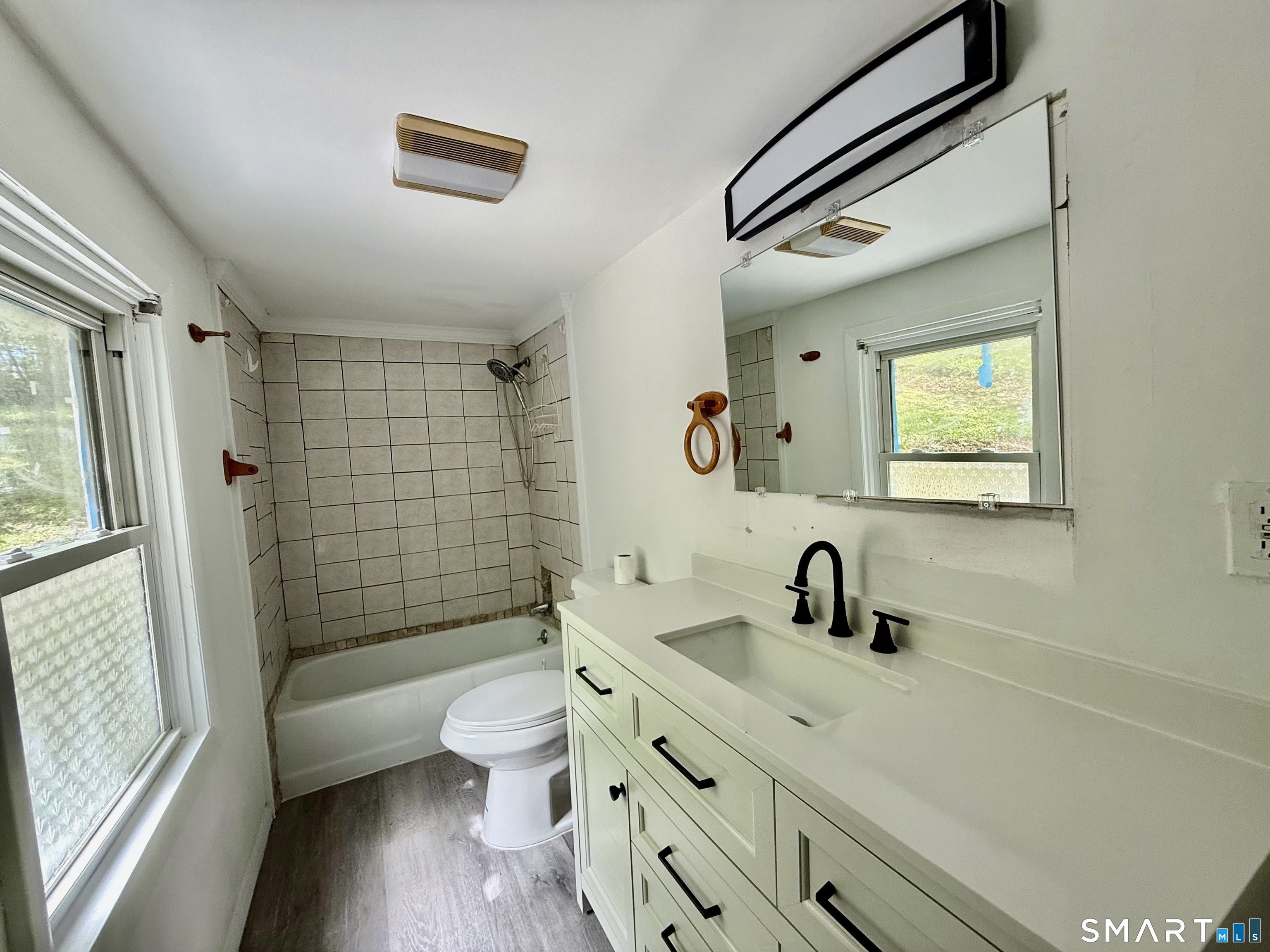277 Lake Road Andover, CT 06232 - Photo 17 of 18 a bathroom with a double vanity sink toilet mirror and shower