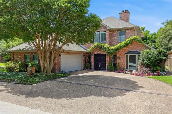 a front view of a house with a yard and a garage