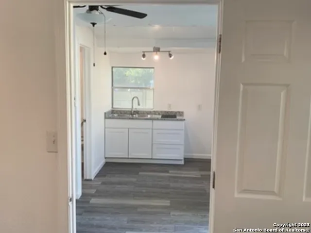 a view of a kitchen from the hallway