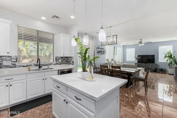 a kitchen with a sink a counter and chairs