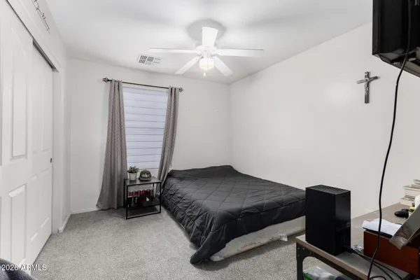 a bedroom with a bed and a television