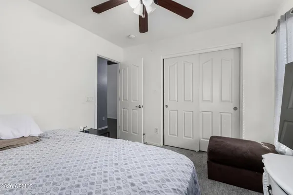 a bedroom with a bed and a couch