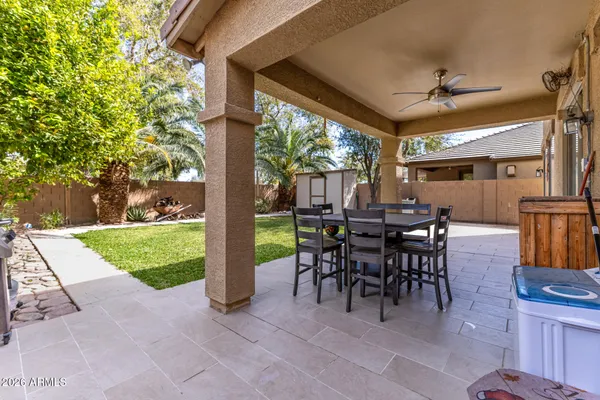 a view of a patio with a table chairs and a backyard