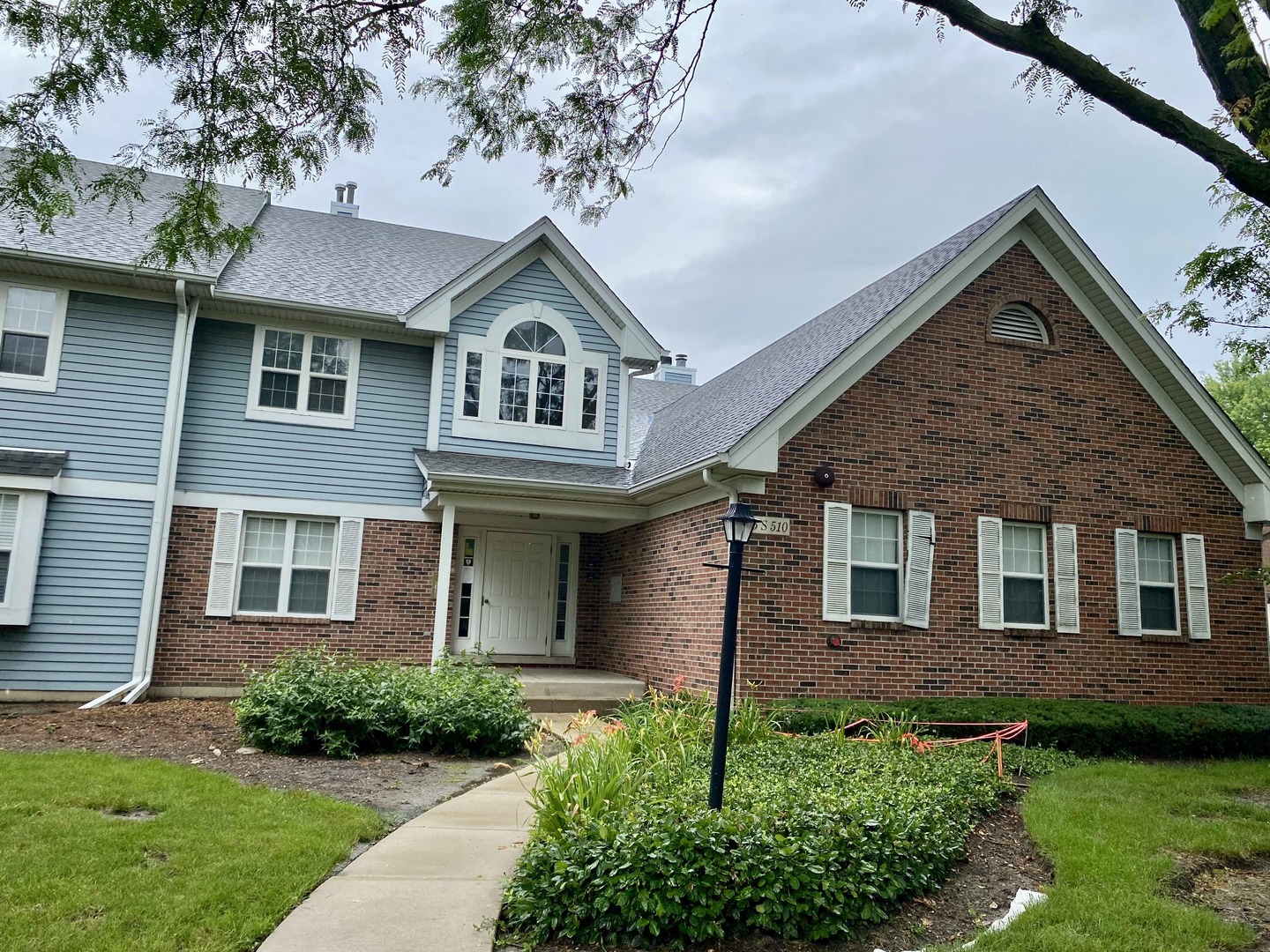 5S510 Scots Drive, Unit G Naperville, IL 60563 - Photo 1 of 1 a front view of a house with a yard