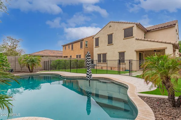 a swimming pool with outdoor seating and yard