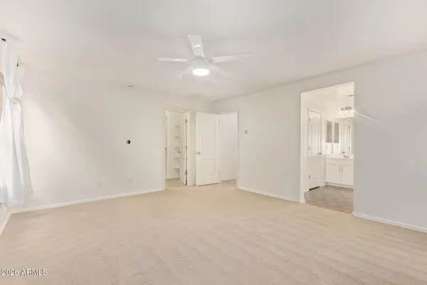 a spacious bathroom with a double vanity sink a mirror and a shower