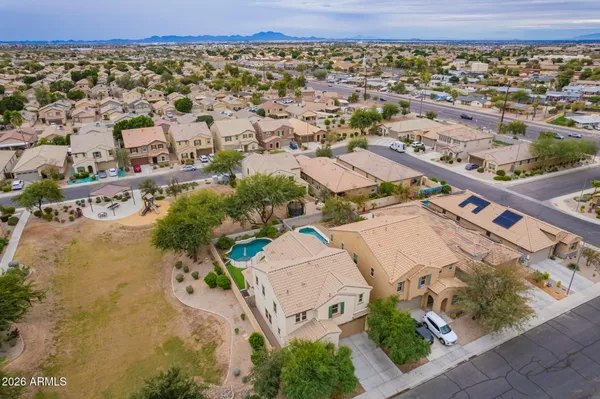 an aerial view of a house with a yard