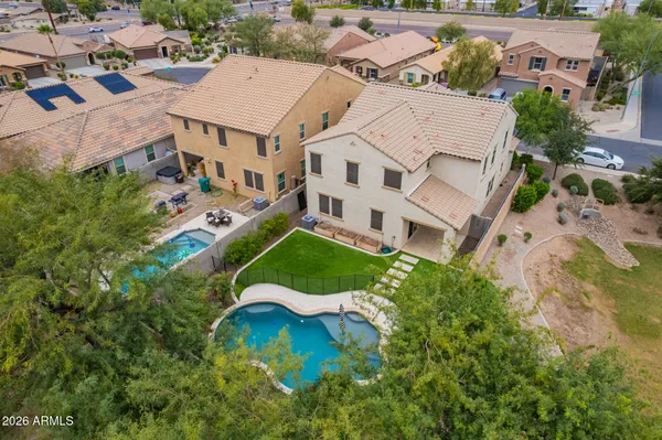 an aerial view of a house with a yard