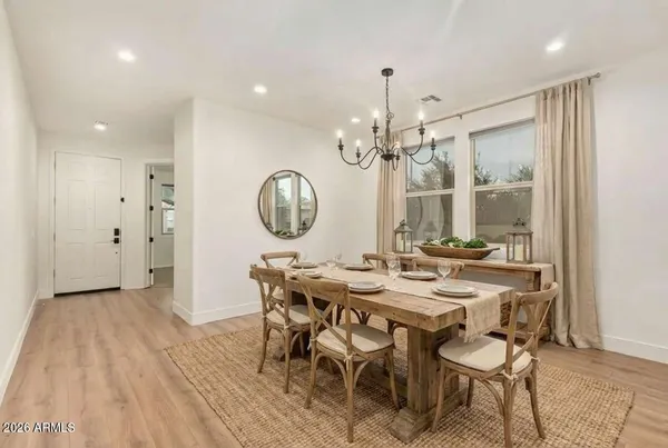 a view of a dining room with furniture and chandelier