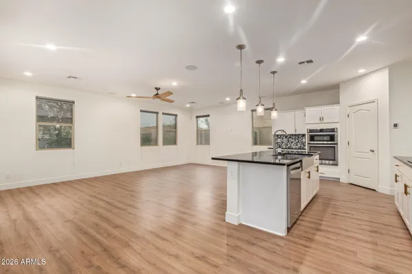 a large kitchen with stainless steel appliances kitchen island granite countertop a large stove a sink and a refrigerator