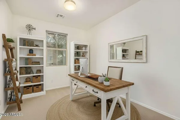 a view of a workspace with furniture and wooden floor
