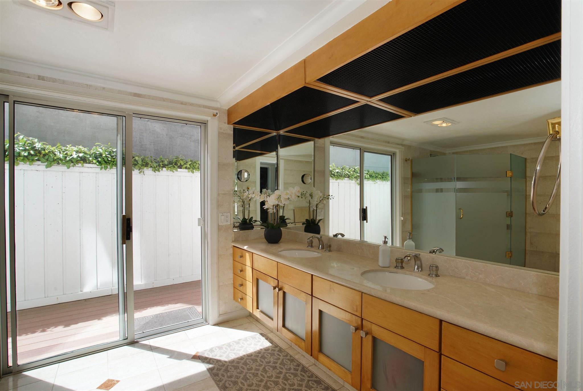57 Blue Anchor Cay Road Coronado, CA 92118 - Photo 13 of 37 a bathroom with a double vanity sink and mirror