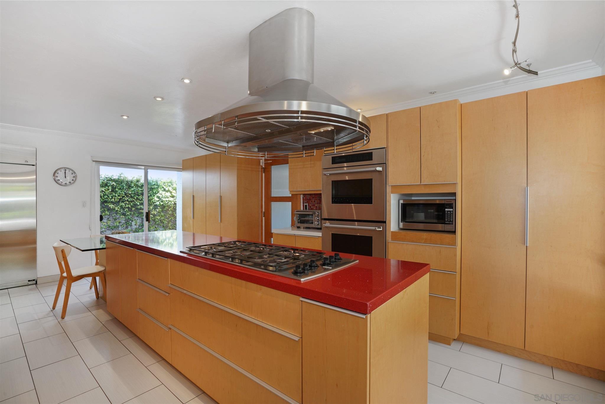 57 Blue Anchor Cay Road Coronado, CA 92118 - Photo 16 of 37 a kitchen with stainless steel appliances granite countertop a stove and a refrigerator