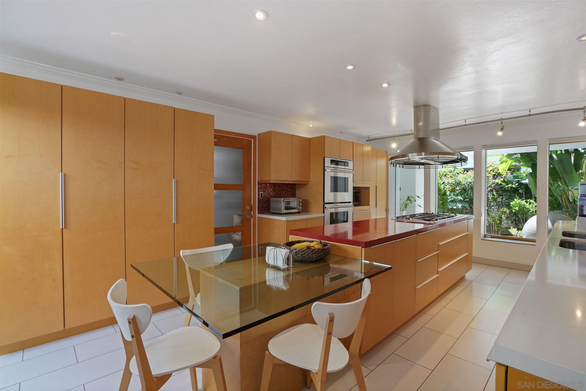 57 Blue Anchor Cay Road Coronado, CA 92118 - Photo 17 of 37 a view of a dining room with furniture a chandelier and wooden floor