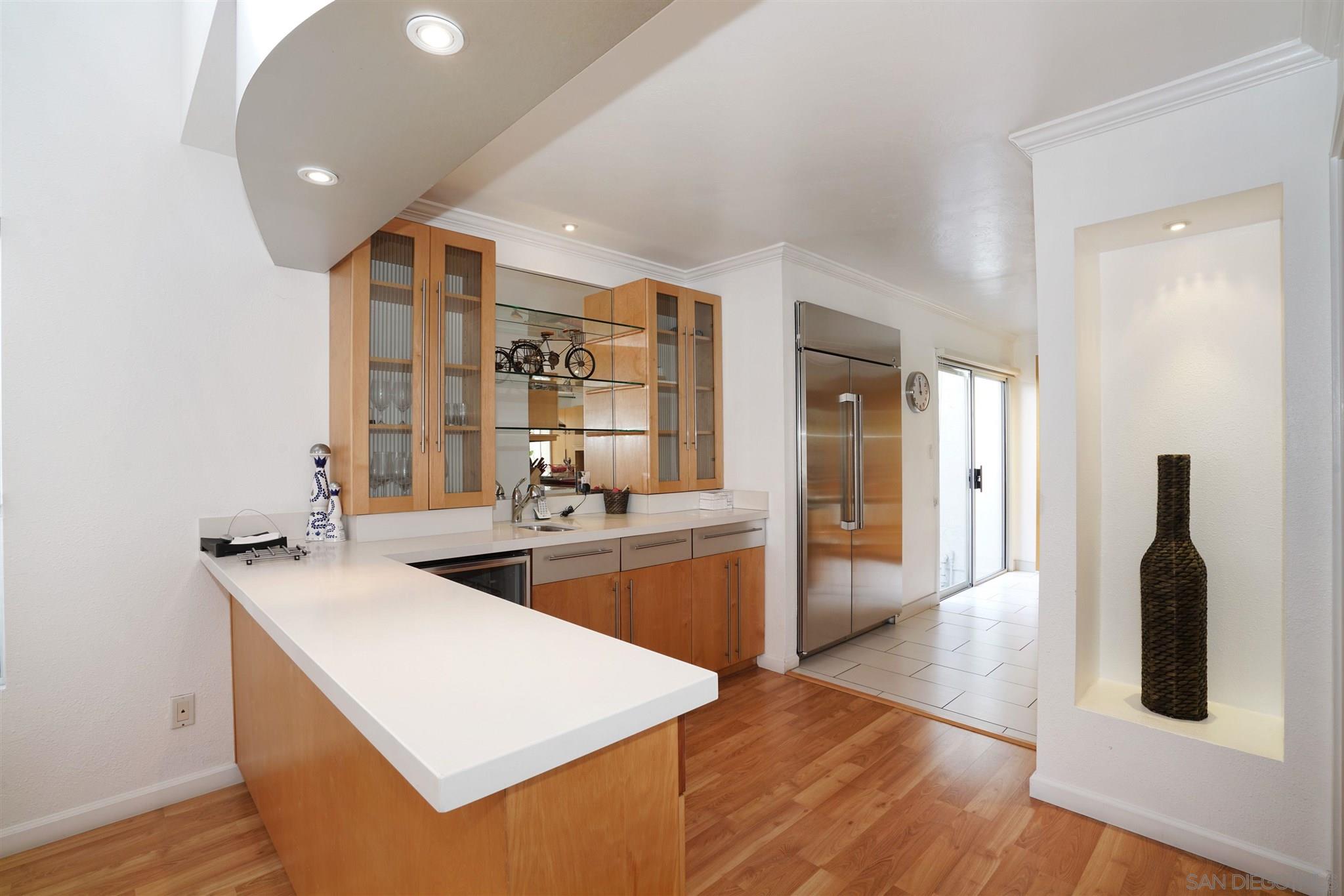 57 Blue Anchor Cay Road Coronado, CA 92118 - Photo 18 of 37 a kitchen with stainless steel appliances granite countertop a sink dishwasher stove and refrigerator with wooden floor