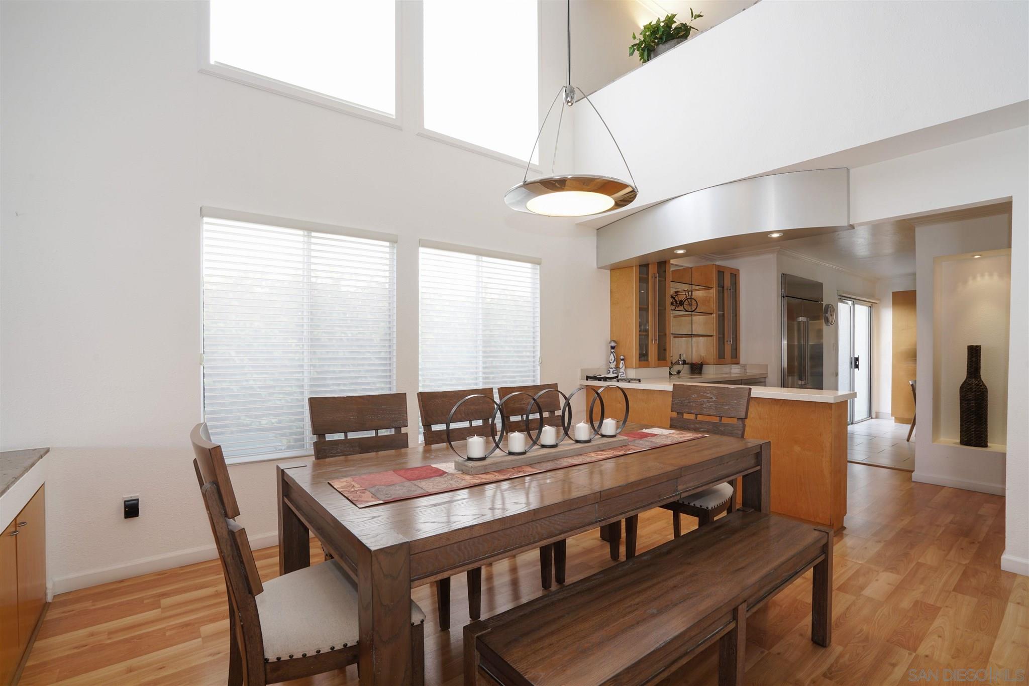 57 Blue Anchor Cay Road Coronado, CA 92118 - Photo 20 of 37 a view of a dining room with furniture wooden floor and chandelier