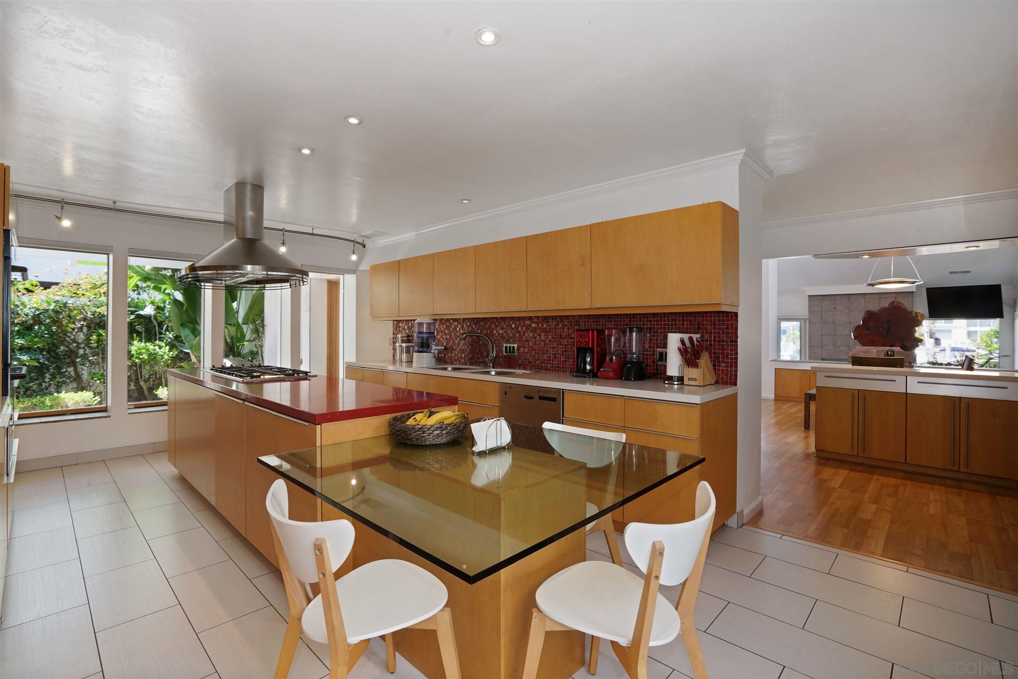 57 Blue Anchor Cay Road Coronado, CA 92118 - Photo 21 of 37 a kitchen with a table chairs and window
