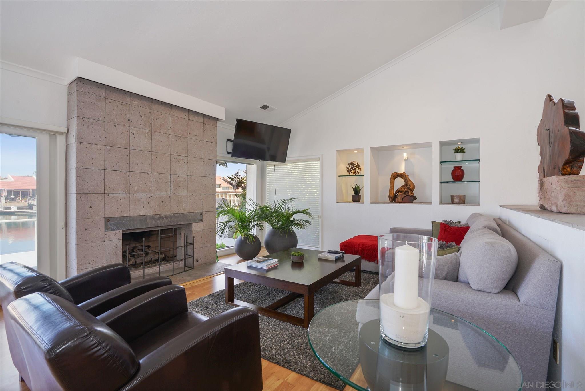 57 Blue Anchor Cay Road Coronado, CA 92118 - Photo 24 of 37 a living room with furniture and a fireplace