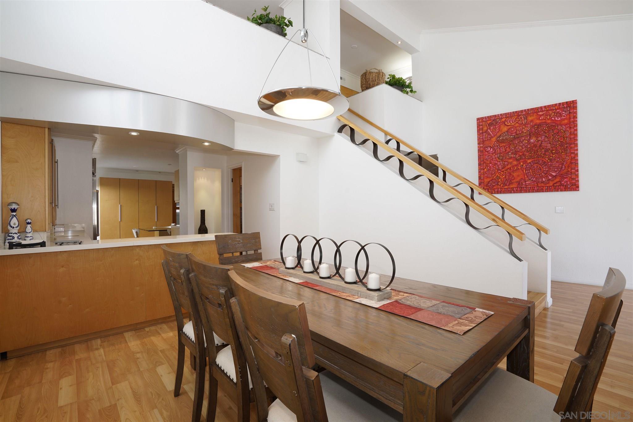 57 Blue Anchor Cay Road Coronado, CA 92118 - Photo 25 of 37 a view of a dining room with furniture and wooden floor