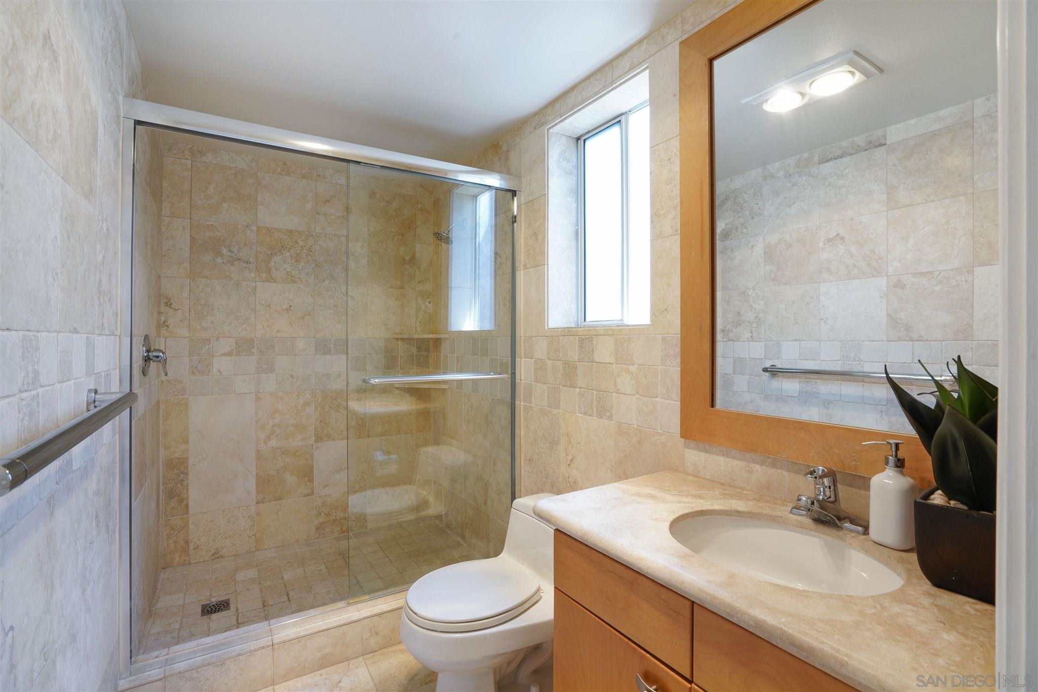 57 Blue Anchor Cay Road Coronado, CA 92118 - Photo 28 of 37 a bathroom with a granite countertop sink toilet and shower