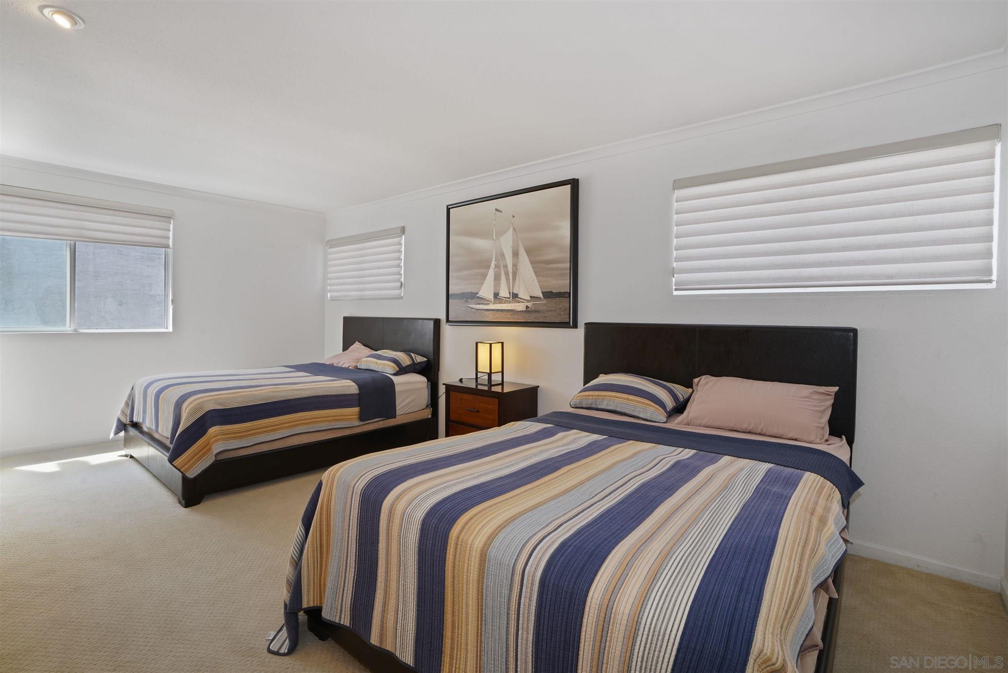 57 Blue Anchor Cay Road Coronado, CA 92118 - Photo 29 of 37 a bedroom with two beds and painting on the wall