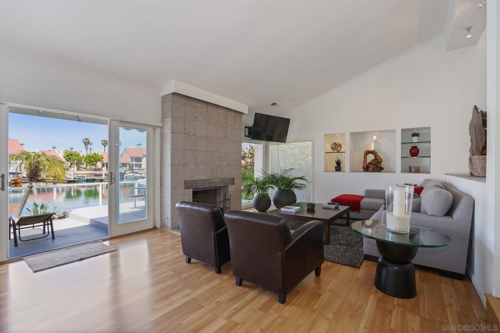 57 Blue Anchor Cay Road Coronado, CA 92118 - Photo 7 of 37 a living room with furniture and a flat screen tv