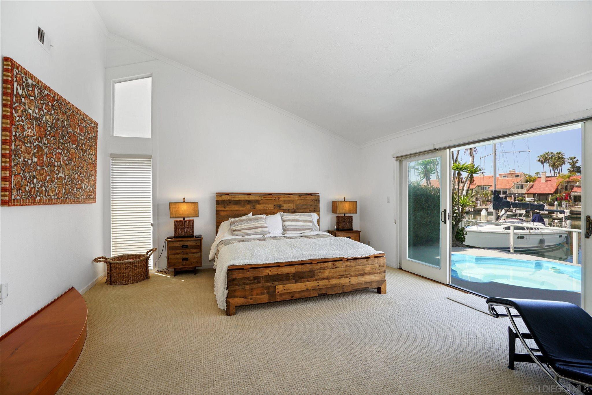 57 Blue Anchor Cay Road Coronado, CA 92118 - Photo 9 of 37 a bedroom with a bed and large window