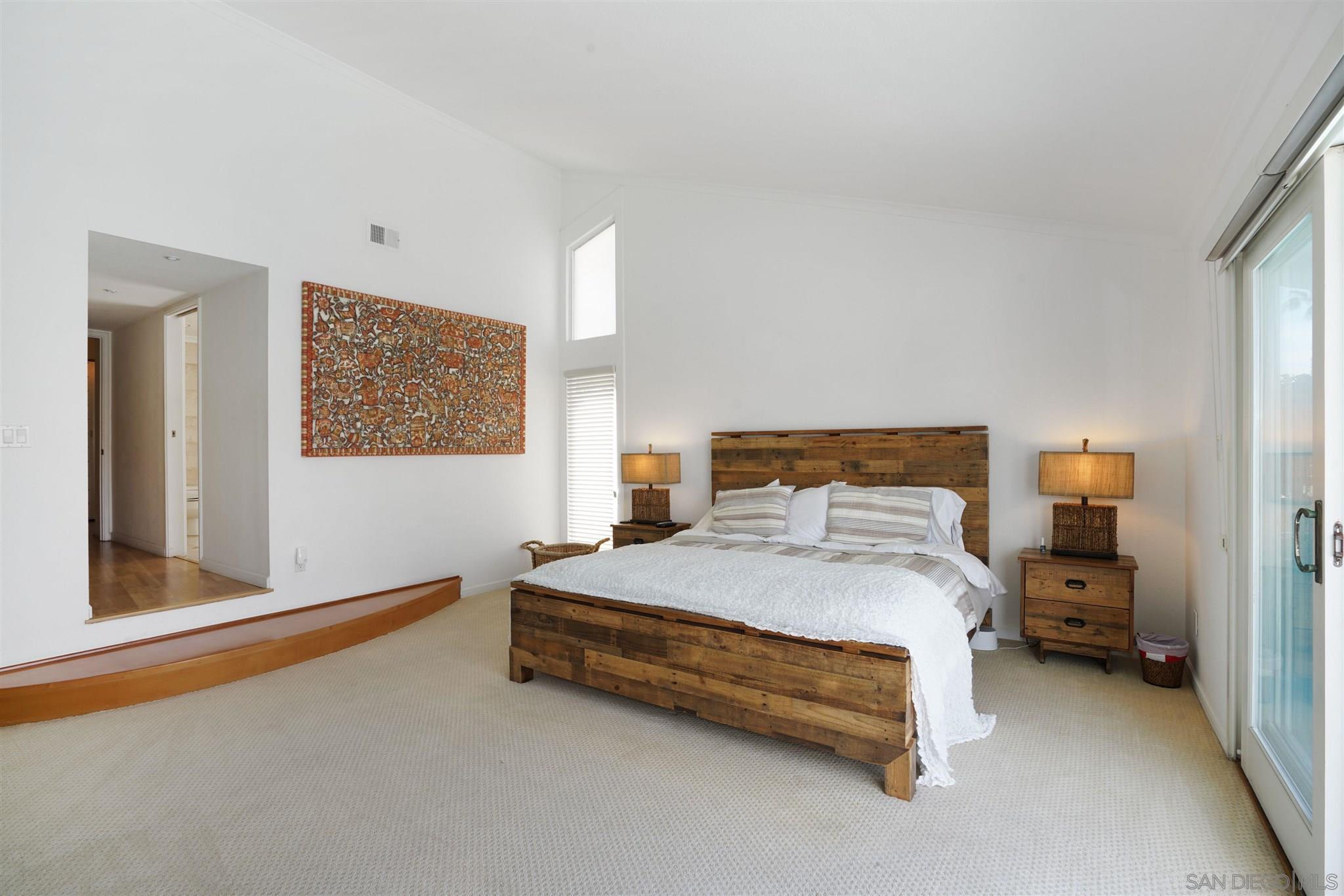 57 Blue Anchor Cay Road Coronado, CA 92118 - Photo 10 of 37 a bedroom with a bed and lamp