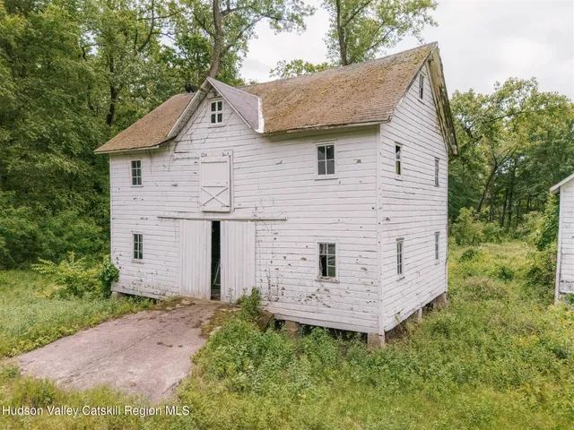 a aerial view of a house with a yard and green space