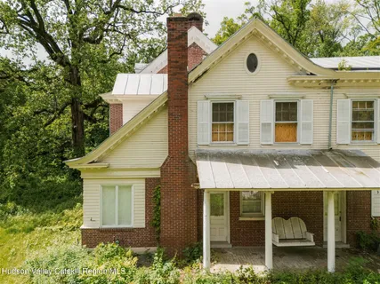 a front view of a house with a garden and plants
