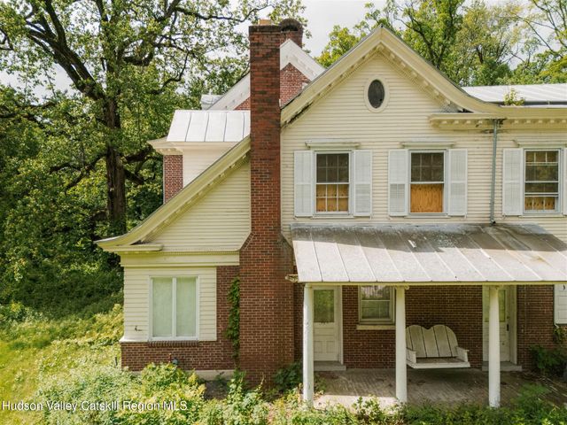 a front view of a house with a garden and plants