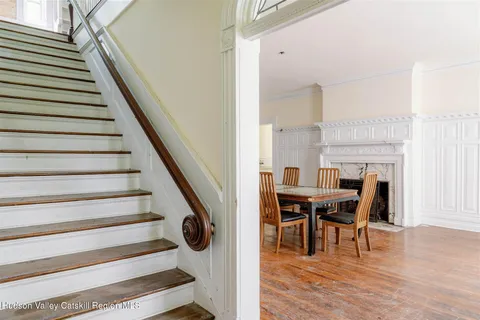 a view of a dining room with furniture window and wooden floor