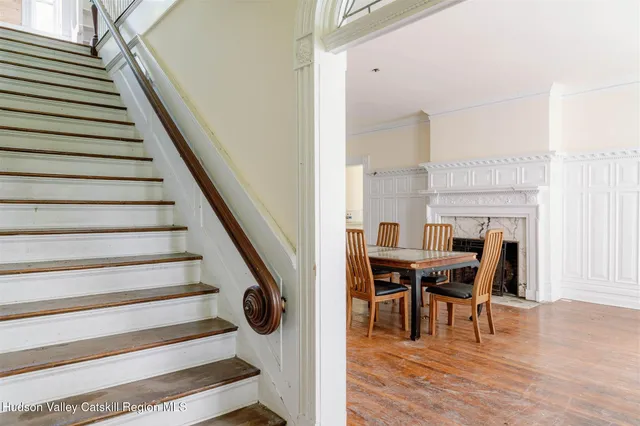 a view of a dining room with furniture window and wooden floor