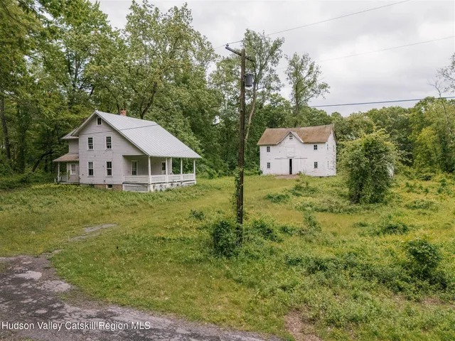 a view of a house with a yard and deck