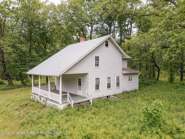 a view of a porch with wooden floor and floor to ceiling window