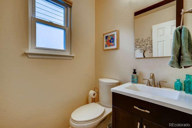 11181 Rodeo Circle Parker, CO 80138 - Photo 12 of 26 a bathroom with a toilet a sink and mirror