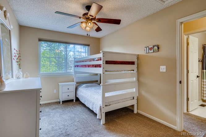 11181 Rodeo Circle Parker, CO 80138 - Photo 17 of 26 a bedroom with a bed and a ceiling fan